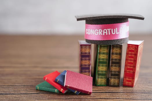 Graduation hat on book with copy space, learning university education.