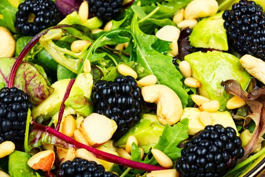Vitamin vegan salad with blackberries, microgreens, avocado and pine nuts. Food background.