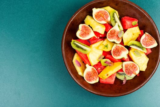 Fruit salad with pineapple, watermelon, kiwi and figs.