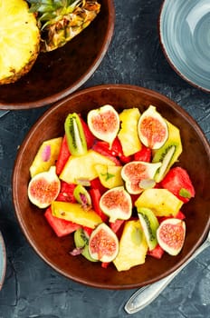 Fruit salad with pineapple, watermelon, kiwi and figs.