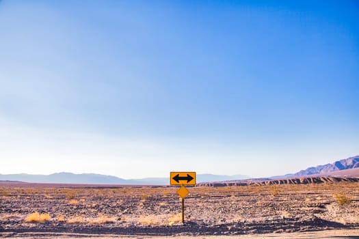 Direction sign in the desert under a blue sky. Concept of uncertain, risk, choice, decision, problem