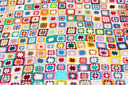 Multi colored blanket in wool, geometric background, retro decorative pattern