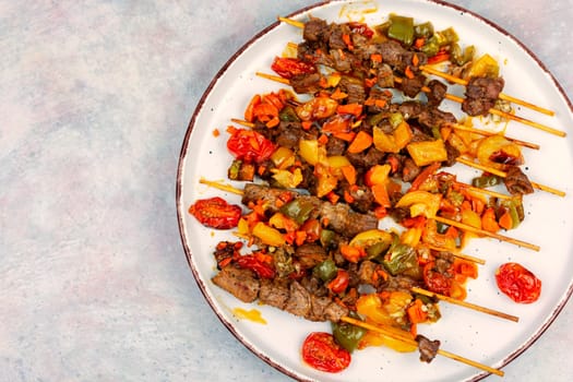Lamb skewers with vegetables. Kebabs or lamb shish kebab. Space for text.