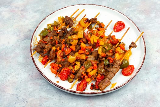 Lamb skewers with vegetables. Kebabs or lamb shish kebab. Space for text.