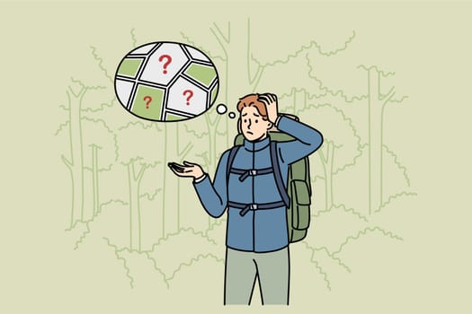 Man gets lost in forest and stands among trees, remembering route to house or highway. Confused guy gets lost and needs help from rescue service to avoid encountering wild animals.