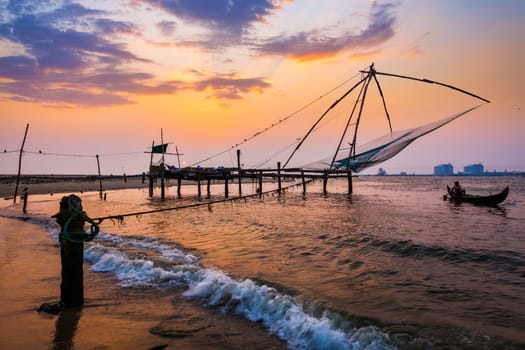 Kochi Chinese fishnets on sunset in Fort Kochin, Kochi, Kerala, India