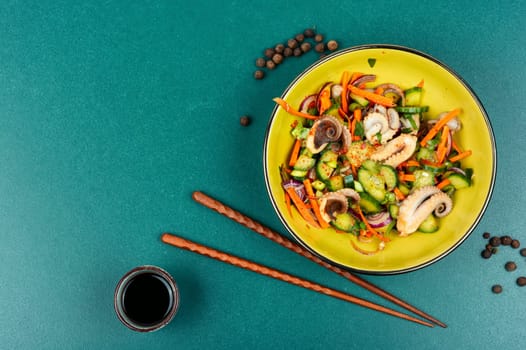 Thai spicy squid or calamari salad in plate. Space for text.