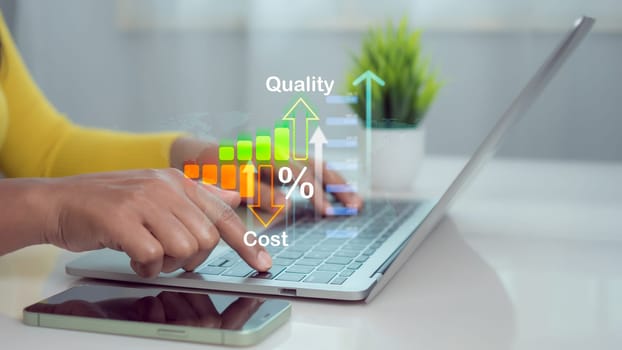 Businesswoman working on computer with quality control growth graph and cost reduction, Effective business, Cost and quality control, business strategy and project management concept.