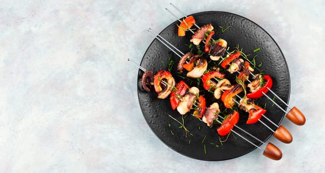 Succulent grilled octopus tentacles with bell pepper on a concrete kitchen table.