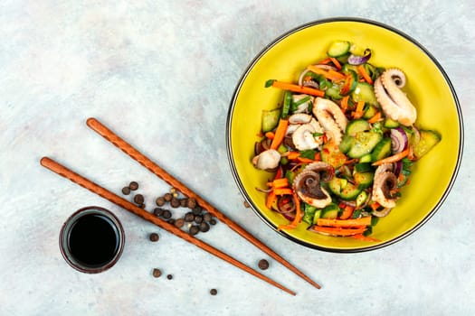 Thai spicy squid or calamari salad in plate. Space for text.