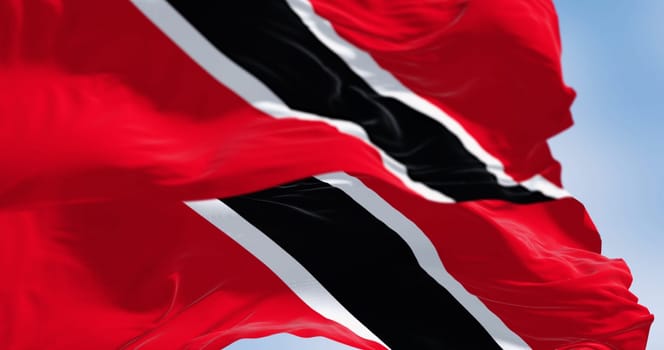 Trinidad and Tobago national flag waving on a clear day. The Republic of Trinidad and Tobago is an island state in the Caribbean. 3d illustration render. Rippled fabric. Selective focus. Close-up