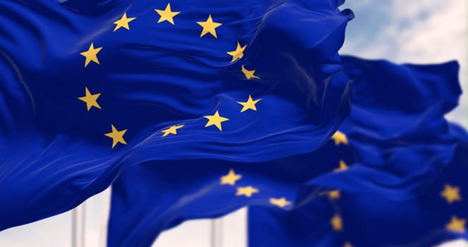 European Union flags waving in the wind on a clear day. The flags symbolize unity and cooperation among the EU member states. 3d illustration render. Selective focus