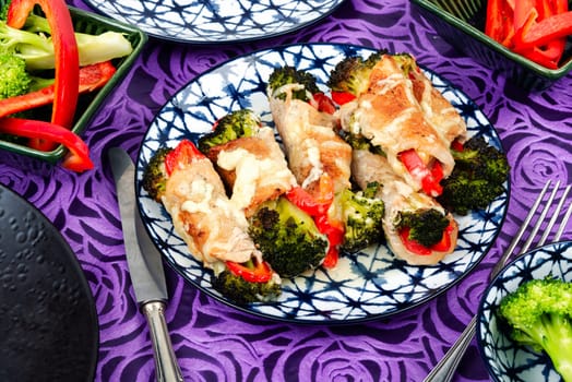 Meat rolls or roulades stuffed with broccoli and peppers. Meat with vegetable filling.