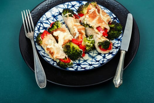Meat rolls or roulades stuffed with broccoli and peppers. Meat with vegetable filling.