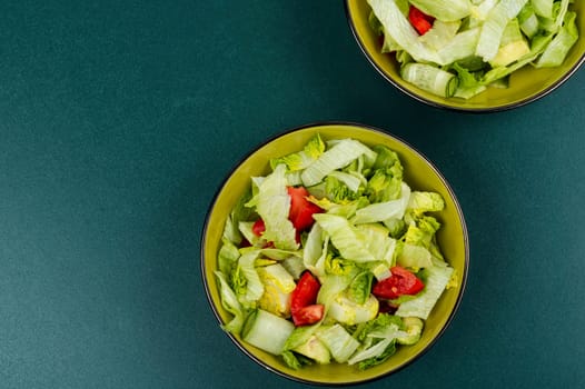Green vegan salad made from a mixture of green leaves and vegetables. Space for text.