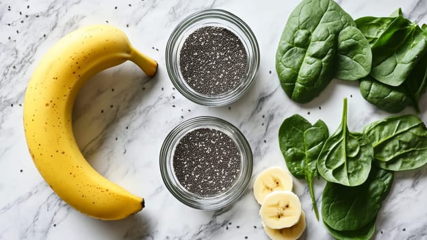 Banana, chia seeds, spinach leaves, and sliced fruit arranged on marble surface, showcasing healthy superfood ingredients for smoothie.