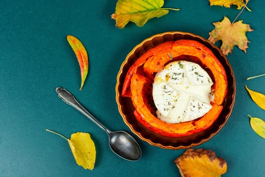 Halved roasted squash filled with spicy and camembert cheese.
