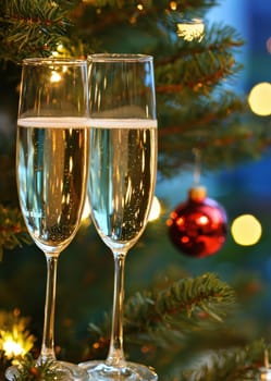 beautiful card with fir tree branches with champagne and garlands for christmas. AI generative.