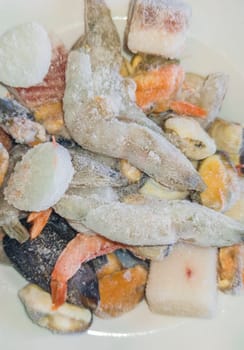 Plate of frozen paella seafood mix. Overhead view