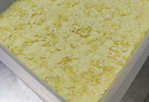 Professional Flaked instant mashed potatoes at plastic fiber container. Selective focus