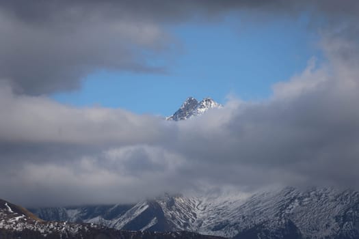 Weather change in the hiking paradise and the holiday region of South Tyrol / Alto Adige with the Rosskopf - thick clouds are gathering,while only the mountain peak looks beyond it