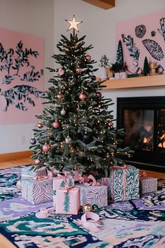 A Christmas tree adorned with ornaments and a star stands surrounded by colorful gifts by a warm fireplace, creating a festive atmosphere.