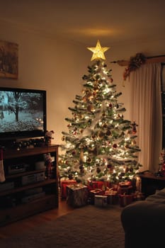 The living room is warmly lit, showcasing a beautifully decorated Christmas tree with presents below, creating a festive atmosphere.