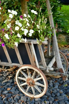 old Bollerwagen with flower decoration in autumn in Germany
