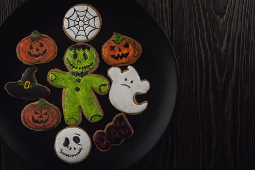 Homemade ginger biscuits for Halloween theme on wooden table