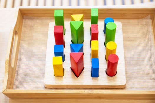 Stylish wooden colorful toy for child on wooden table.