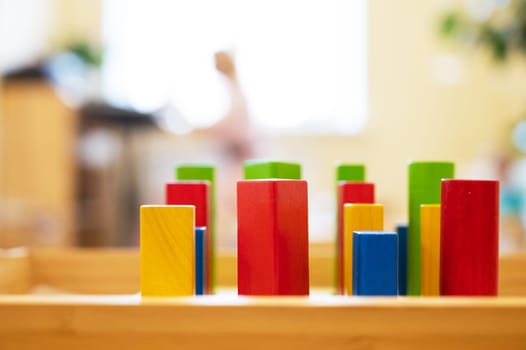 Stylish wooden colorful toy for child on wooden table.