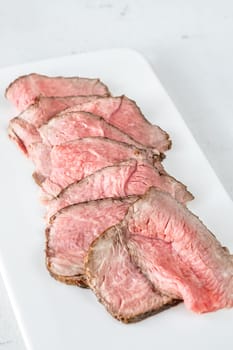 Portion of sliced roast beef on the plate