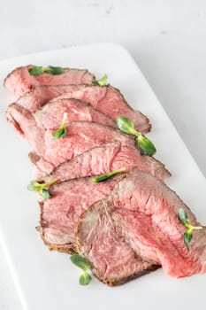 Portion of sliced roast beef on the plate