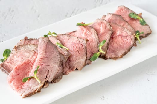 Portion of sliced roast beef on the plate