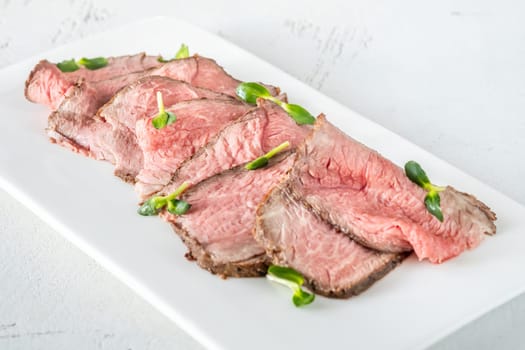 Portion of sliced roast beef on the plate