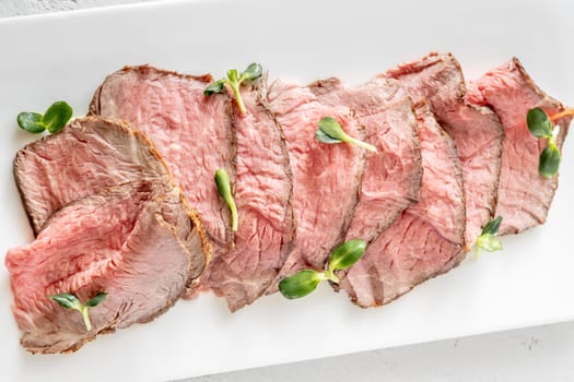 Portion of sliced roast beef on the plate