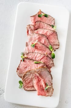 Portion of sliced roast beef on the plate