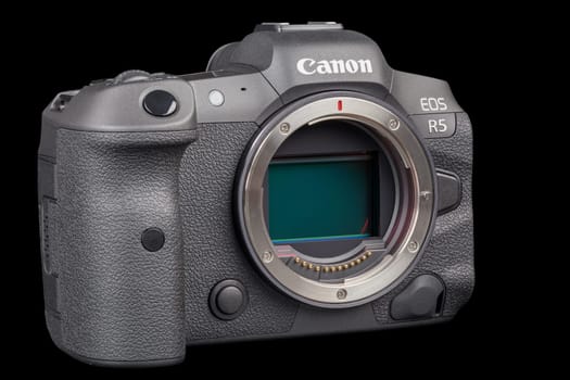Canon R5 - black professional 35mm full-frame mirrorless camera body with flip screen isolated on black background with focus stacking - Tula, Russia, September 15, 2021