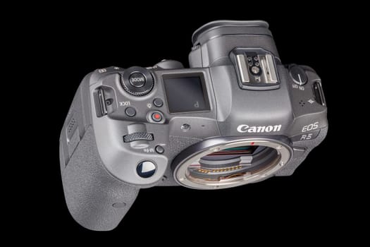 Canon R5 - black professional 35mm full-frame mirrorless camera body with flip screen isolated on black background with focus stacking - Tula, Russia, September 15, 2021