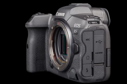 Canon R5 - black professional 35mm full-frame mirrorless camera body with flip screen isolated on black background with focus stacking - Tula, Russia, September 15, 2021