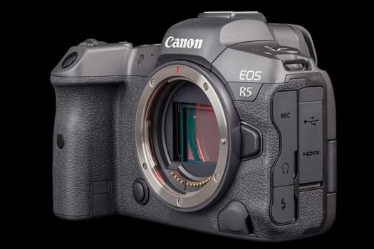 Canon R5 - black professional 35mm full-frame mirrorless camera body with flip screen isolated on black background with focus stacking - Tula, Russia, September 15, 2021