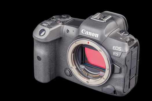 Canon R5 - black professional 35mm full-frame mirrorless camera body with flip screen isolated on black background with focus stacking - Tula, Russia, September 15, 2021