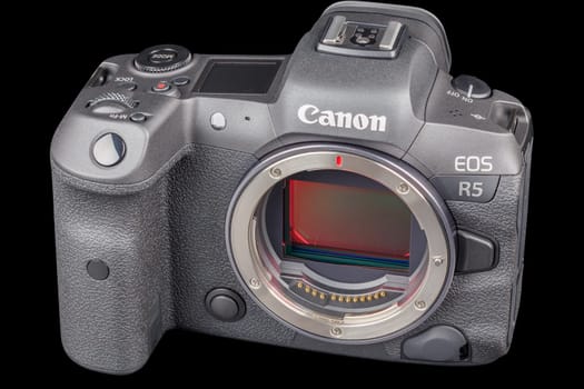 Canon R5 - black professional 35mm full-frame mirrorless camera body with flip screen isolated on black background with focus stacking - Tula, Russia, September 15, 2021