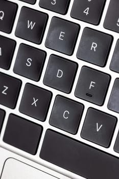 keyboard of famous silver colored laptop with fingerprints, closeup
