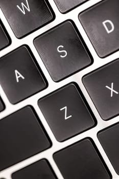keyboard of famous silver colored laptop with fingerprints, closeup