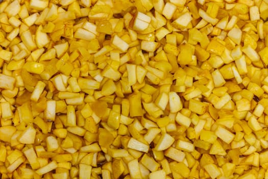 full-frame background and texture of many yellow apples sliced in order to make an apple jam