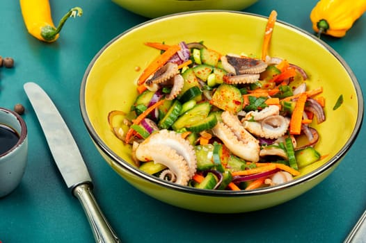 Thai spicy squid or calamari salad in plate. Summer food menu.