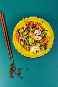 Colorful and tasty salad of squid tentacles or calamari and vegetables in a bowl.