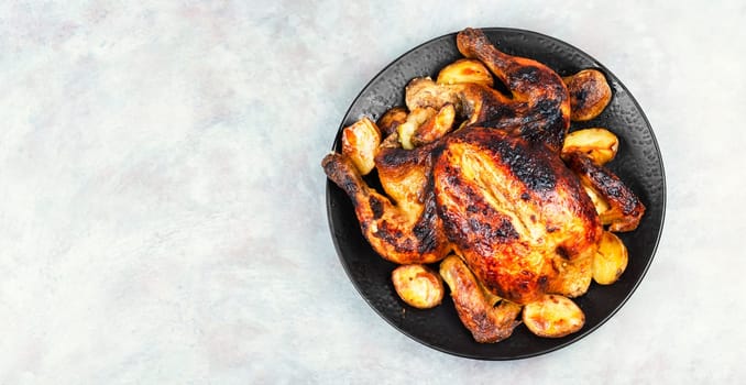 Delicious baked chicken with apples is appetizing served on a ceramic dish. Copy space. Menu, recipe place