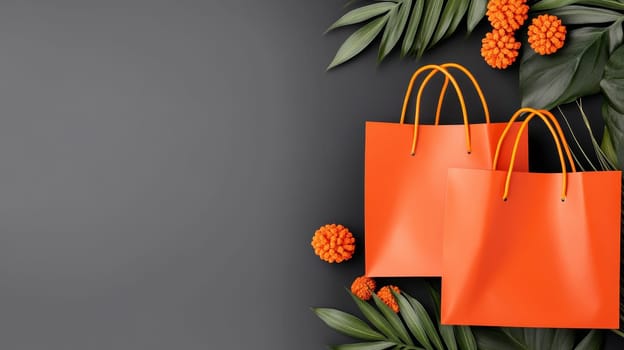 Two vibrant orange shopping bags surrounded by green leaves and flowers, offering a festive touch with copy space.